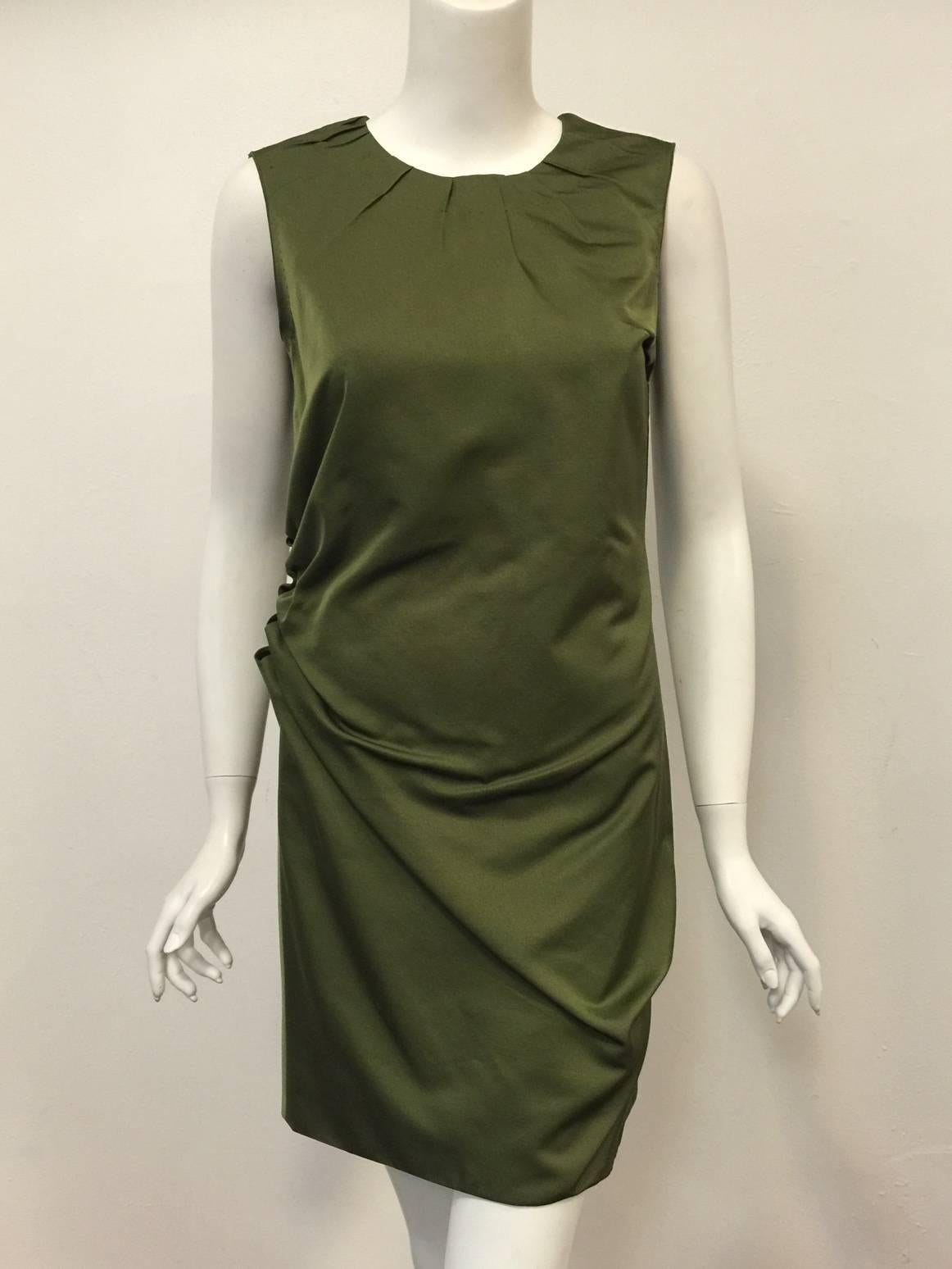 Marc Jacobs Sleeveless Sheath illustrates his extensive previous experience as head designer for Louis Vuitton.  Features a classic silhouette rendered in olive wool and silk.  Worthy of Bergdorf Goodman, dress has round neckline with pintuck