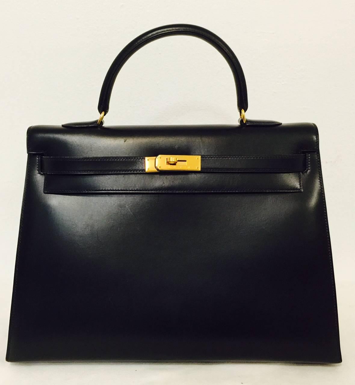 This 1993 Hermes Black Box Calf Kelly 35 with gold hardware is the ultimate symbol of status and luxury originally crafted for Princess Grace Kelly of Monaco herself! A classic staple every fashion forward woman's wardrobe should feature. Each Kelly