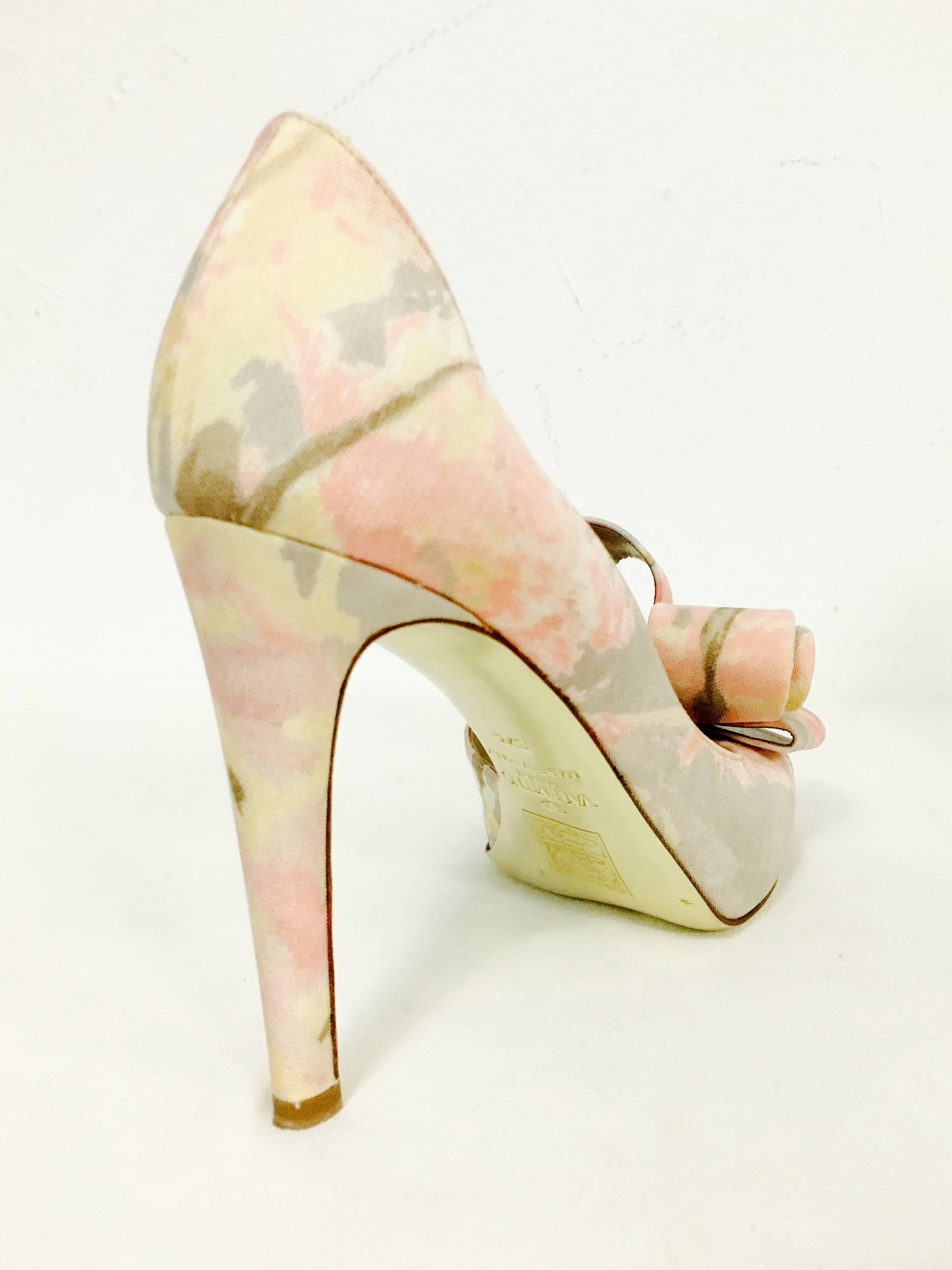 High Heels are typical Valentino Garavani...sophisticated, chic, and so very feminine!  Features abstract floral print in shades of petal pink, fuschia, yellow and taupe.  Covered heels, peep toe, open instep and gold metallic leather soles complete