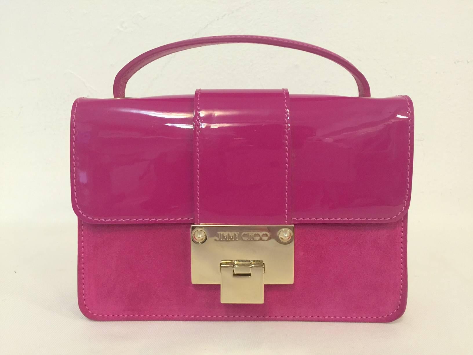 This bag proves that Jimmy Choo is so much more than a highly desired shoe designer!  Luxurious and chic, this Jimmy Choo bag is perfect for day and easily makes an unforgettable statement at night.  Crafted from supple fuschia suede, exterior is