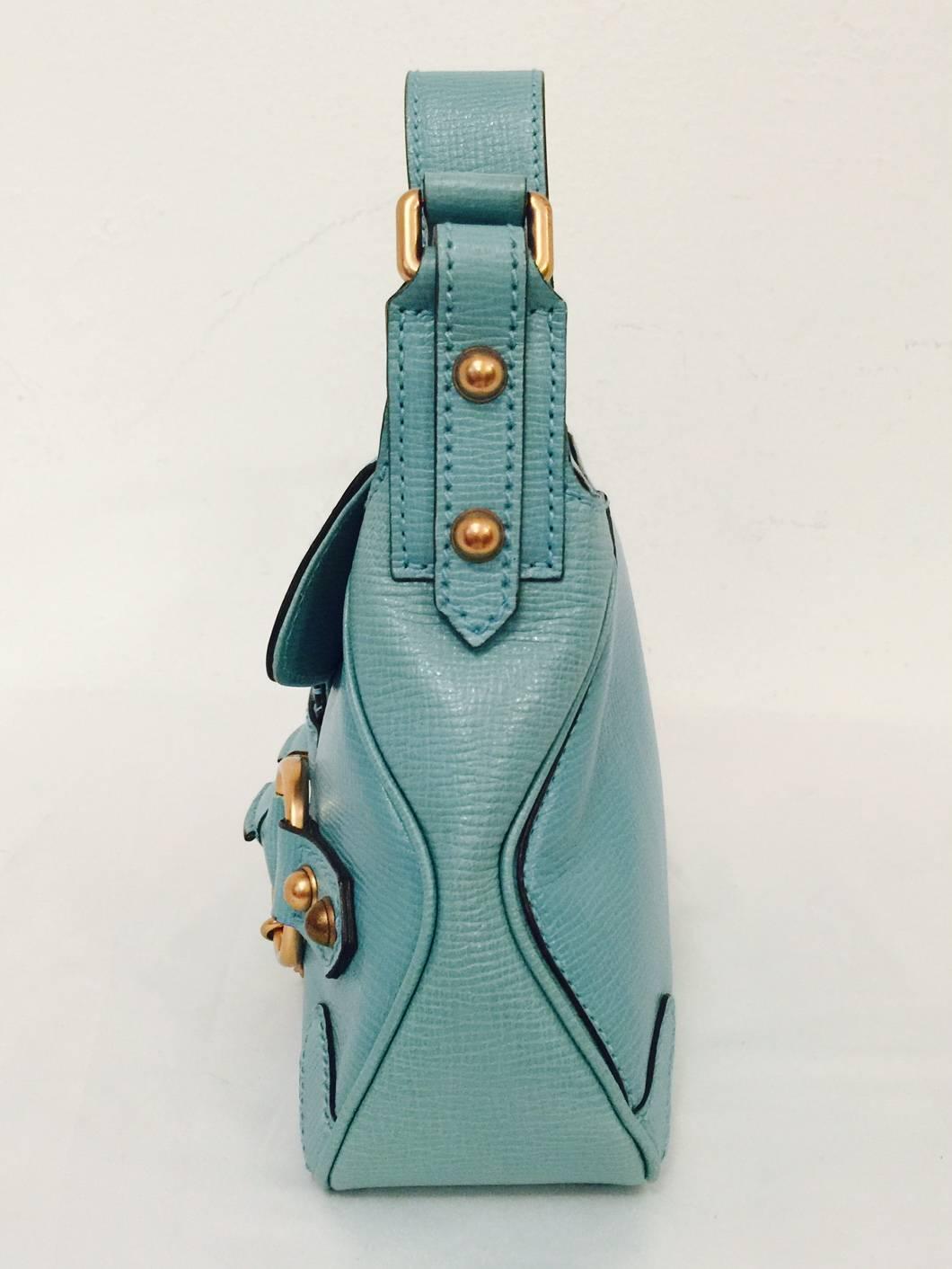 Textured Aqua Leather Shoulder Bag is undeniably Gucci!  Features exquisite Italian leather and craftsmanship, front flap, and adjustable shoulder strap.  Aqua leather and fabric interior houses one zippered compartment. The finishing touch?  One