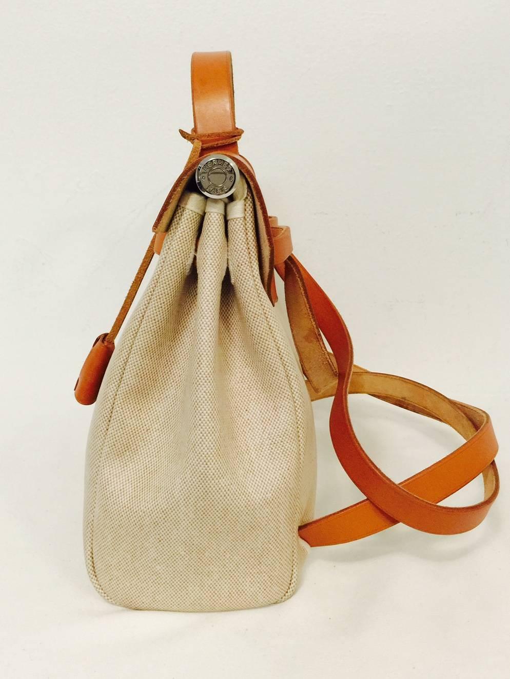 2 bags for the price of one!  Immaculate beige toile Hermès Herbag PM bag with tan leather trim will be admired from afar and up close!  The set comes with two bottom beige canvas shells and an interchangeable leather top.  Top handle or shoulder