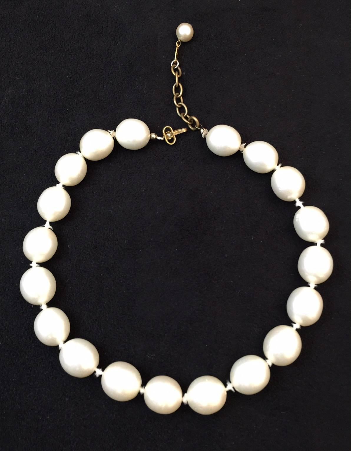 The staple of every ladies wardrobe:  Pearls!  Who better to design with pearls than Coco Chanel? This necklace is purely classic.  Gold tone chain can adjust from 16 to 17