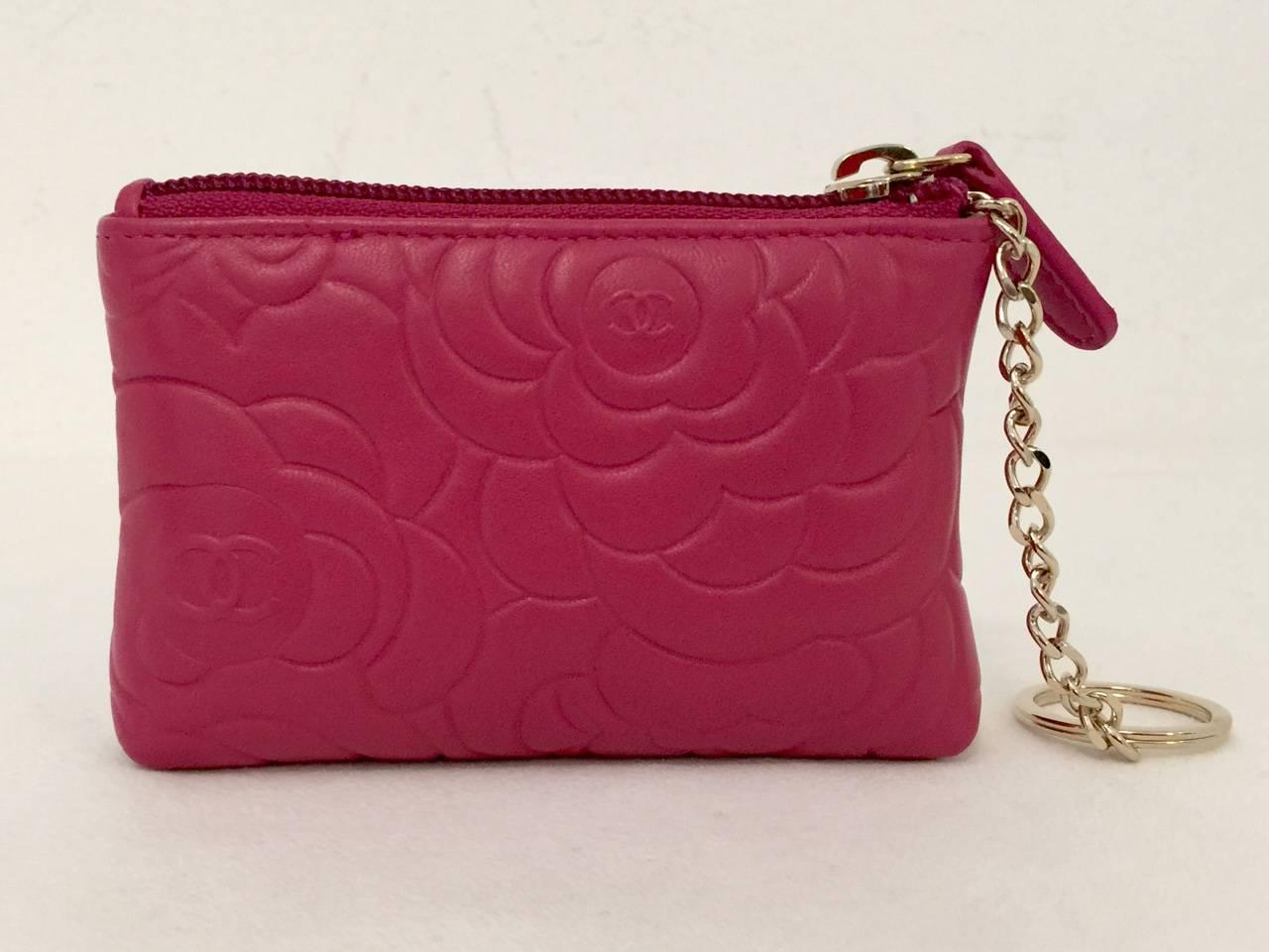 Chanel Leather O-Key Holder With Box is a must for any Chanelophile!  Features luxurious fuchsia leather stamped with the inimitable camellia and double 