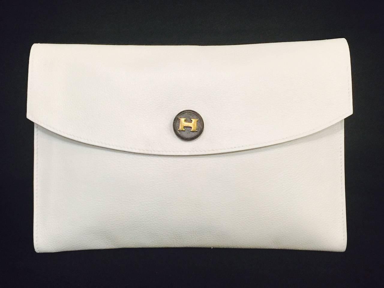 Fit for a lady, this  Vintage Hermes White Leather  Clutch is a wonderful addition to any connoisseur's collection!  Features the most sublime, supple leather, classic "envelope" design and GHW.  Slightly curved flap, white stitching all