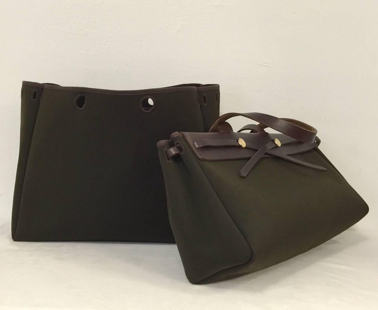 No longer in production, this Hermes Green Canvas Cabas Herbag is highly desired and coveted around the globe!  In Above Excellent Condition, bag (actually bags!) features luxurious dark loden green fabric exterior and durable, yet luxurious brown