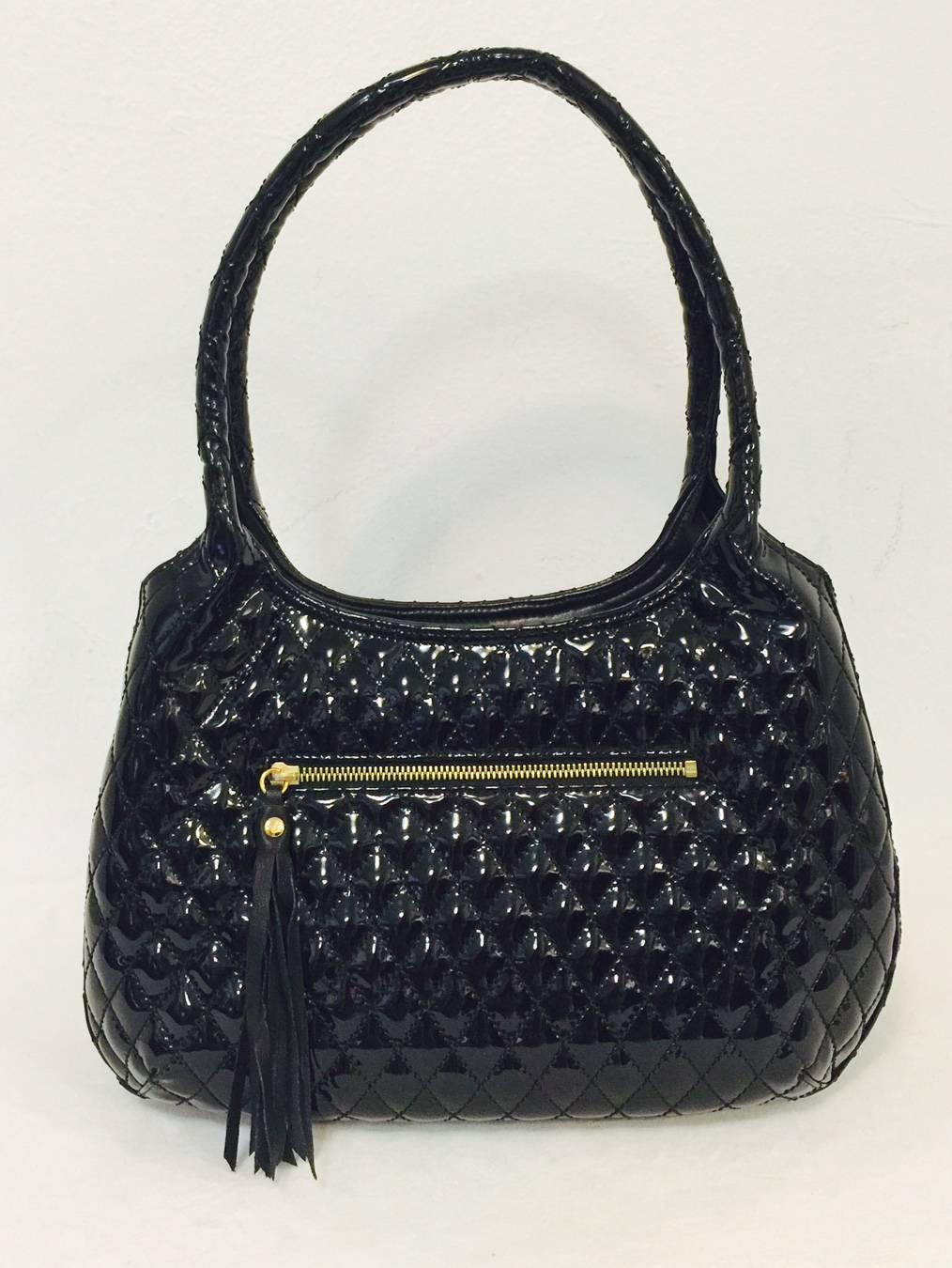 Black Patent Shoulder Bag With Tassel proves that Eric Javits is so much more than a mere milliner!  Features Diamond Quilted design allover and double rolled shoulder straps.  One exterior flap pocket and one exterior zippered pocket provide