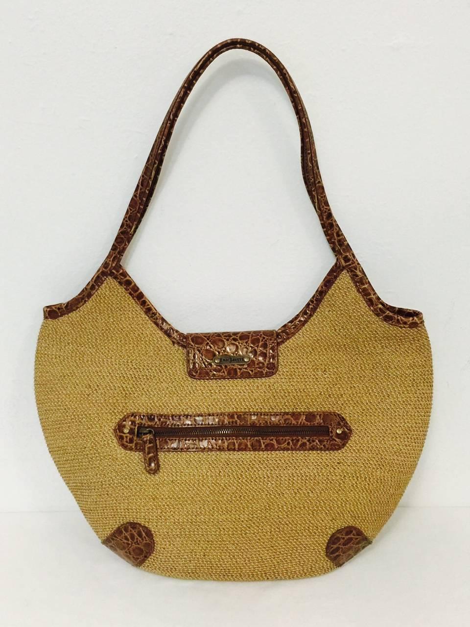 Go to market in style with Eric Javits' Tan Jute Hobo Bag!  Features classic and durable jute exterior and tan canvas interior perfectly complemented by warm brown crocodile embossed leather trim inside and out.  Interior houses several open pockets