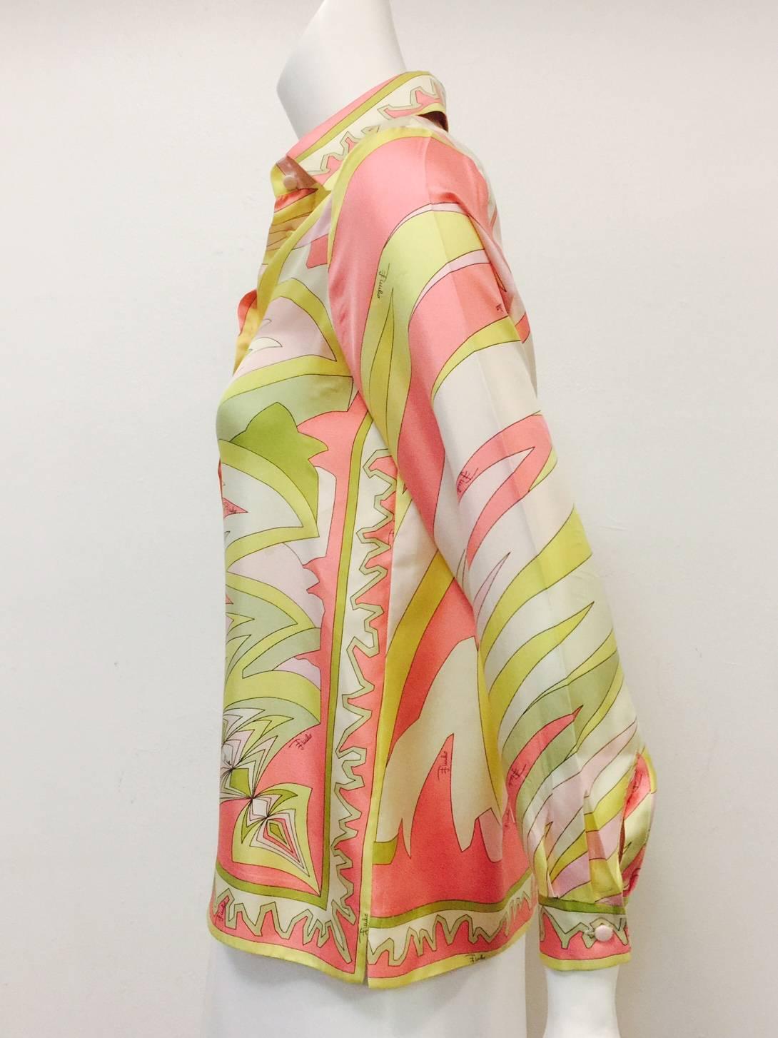 Exquisite Emilio Pucci Blouse is worthy of any connoisseur's collection!  Features Palm Beach pink, melon, Spanish olive and sunburst yellow abstract print all over and 6 covered buttons.  Straight hem with side slits and double-faced spread collar