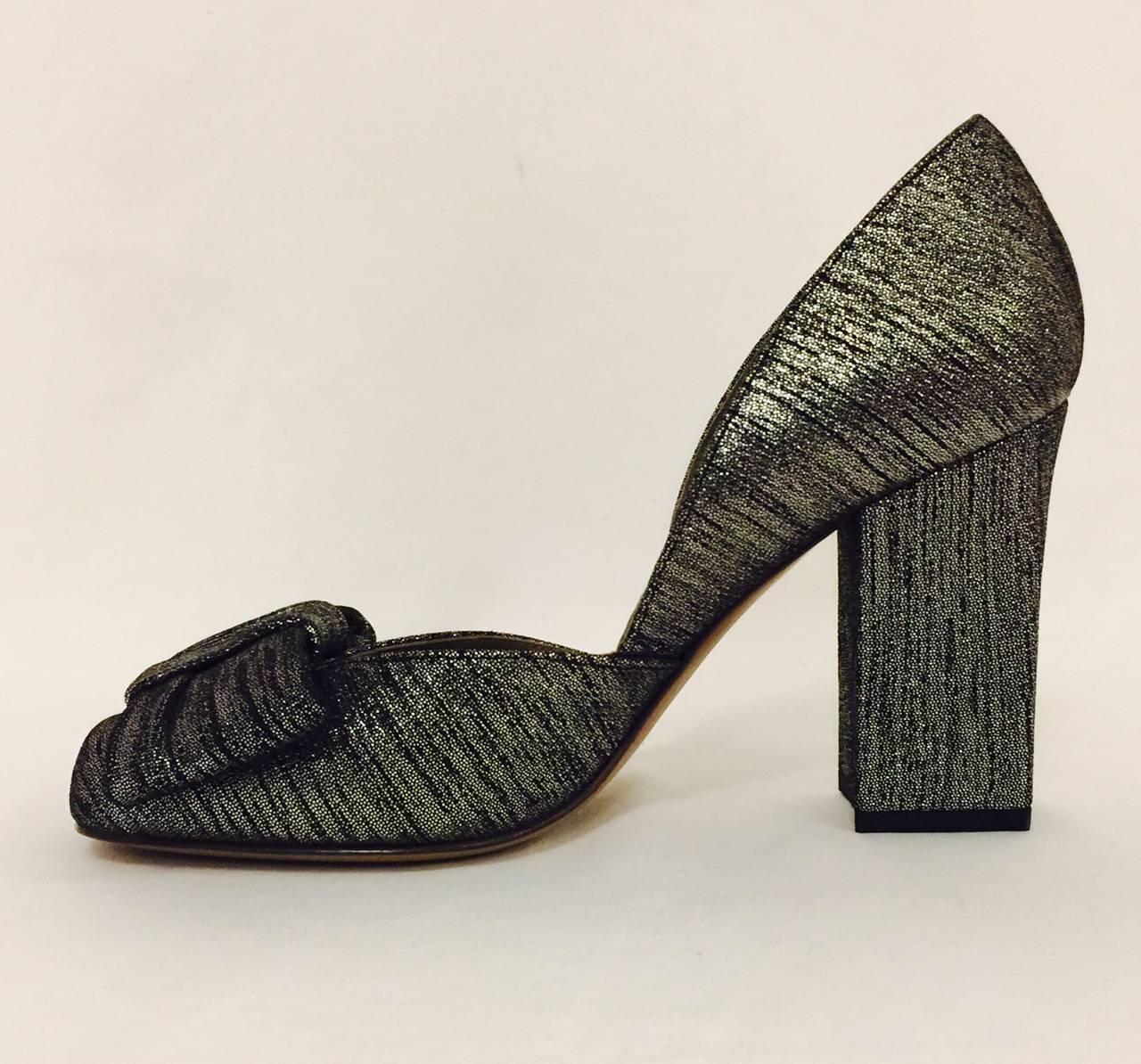 Marni Black and Silver Metallic Suede Evening Pumps add a new dimension to "Evening".  Shoes feature rounded square toes and covered high block heels.  Leather soles, lining, and insoles.  A large flat bow finishes the look!  Made in