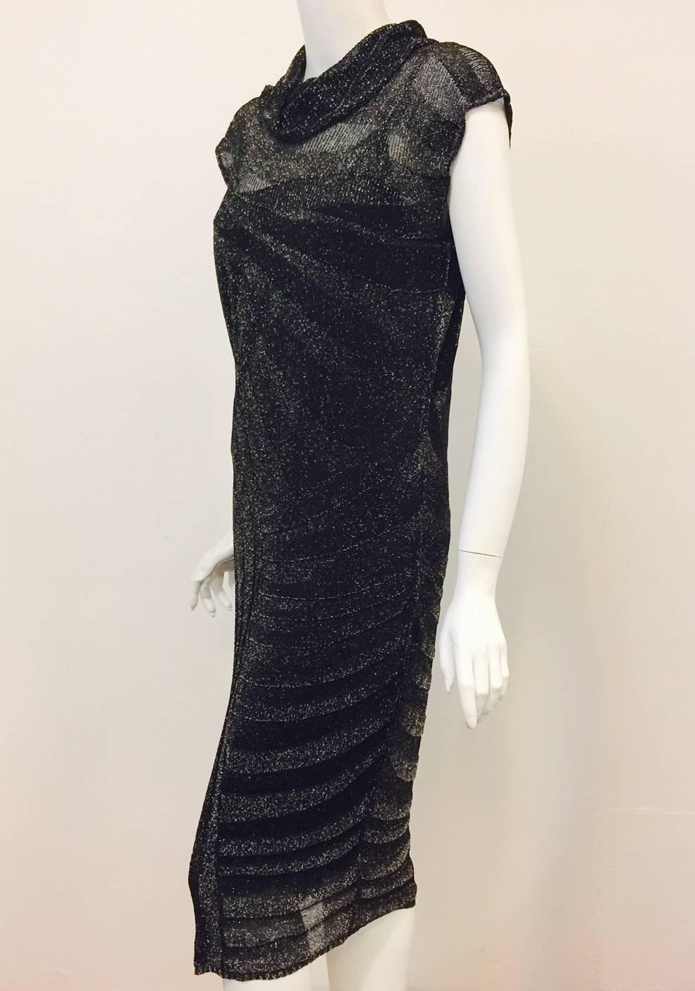 New Escada Black Knit Cap Sleeve Dress is lightweight and substantial at the same time!  Features body conscious, below-the-knee  silhouette, complex, asymmetric knit pattern from neck to hem, and cap sleeves.  Black with just the right amount of