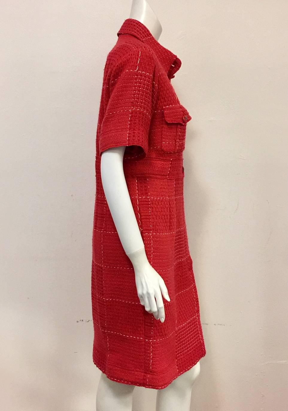 Classic Shirt Dress styling meets couture in Chanel's Strawberry Red Wool Dress!  Features signature substantial tweed fabric, spread collar, on-seam pockets and two patch pockets with buttons.  Front closure has two visible buttons and a placket
