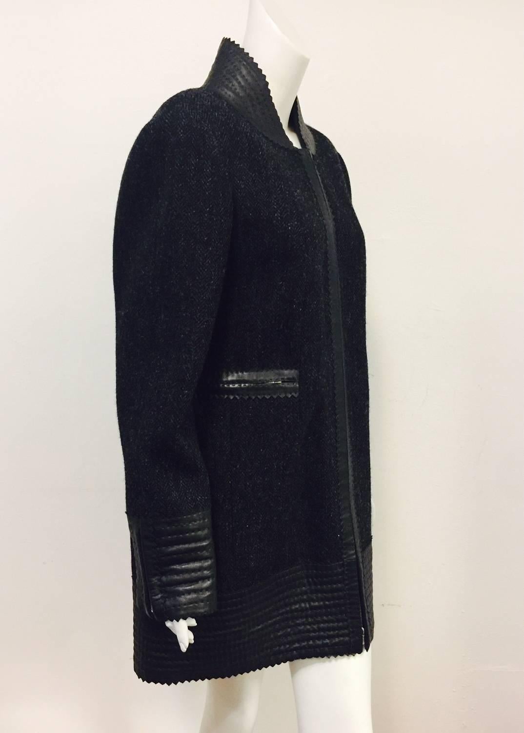 Chanel Black and Grey Herringbone Tweed Coat is modern, chic, with just the right amount of "edge"!   Features somewhat futuristic design and silhouette finished with zig zag finished, channel quilted lambskin deep hem, cuffs, and standup
