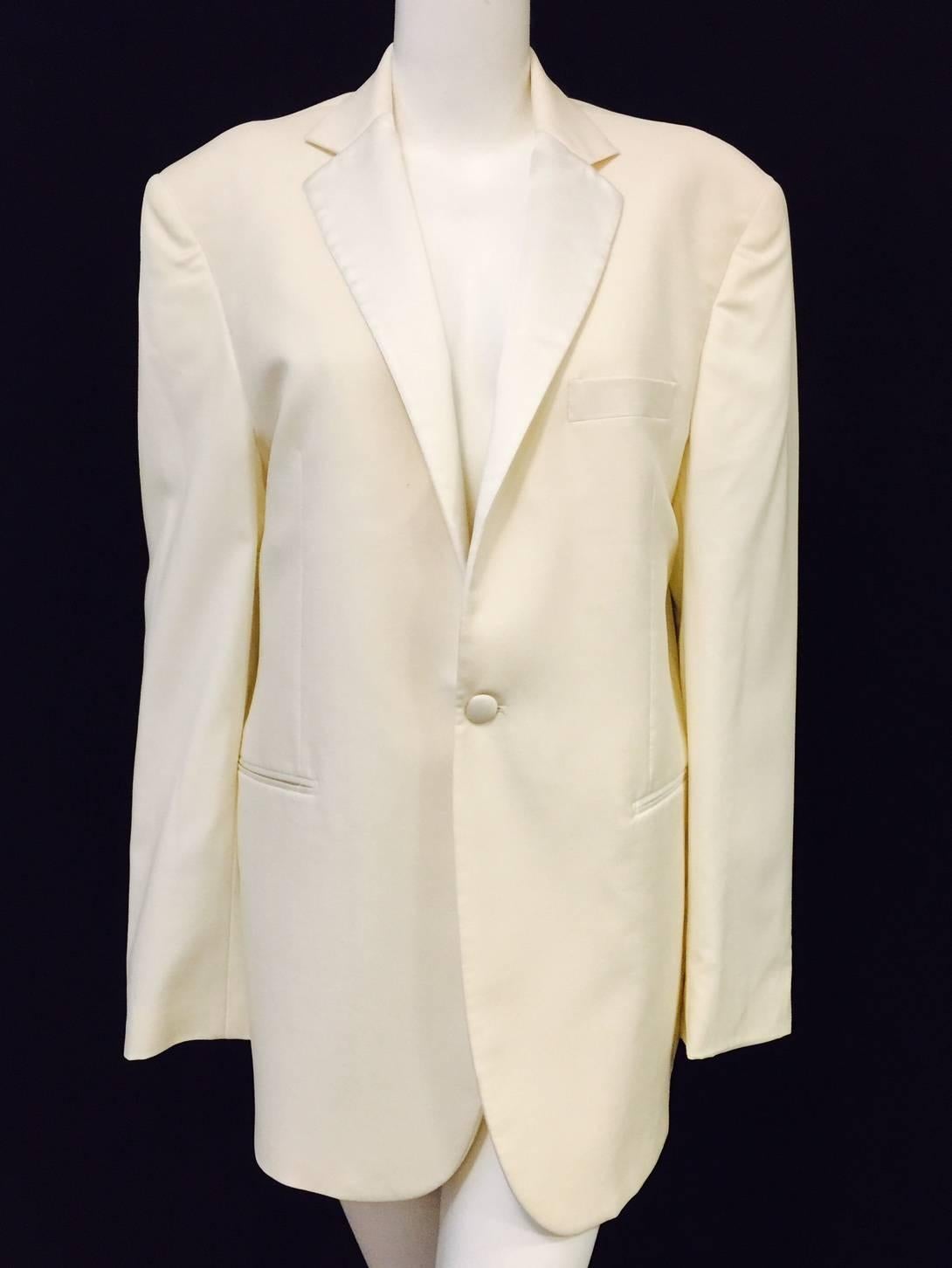 Ooo-la-la!  Yves Saint Laurent Ivory Wool Dinner Jacket is worthy of any Award Season.  Features notch collar with satin trim, two welt pockets, one breast pocket and single satin-covered button closure.  Satin interior houses 3 pockets.  Ventless