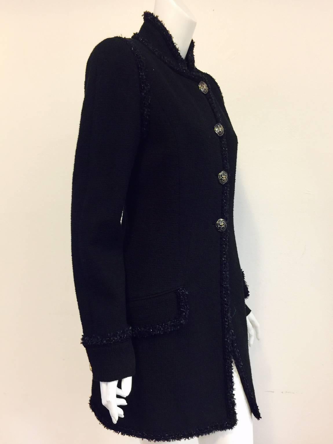 Chanel Black Tweed Coat is a must for any "Coco Connoisseur"!  Influenced by coats worn by officers of years past, coat features ultra luxurious 100% Cotton fabric, elongated silhouette and standup collar.  Two front flap pockets.  Rear