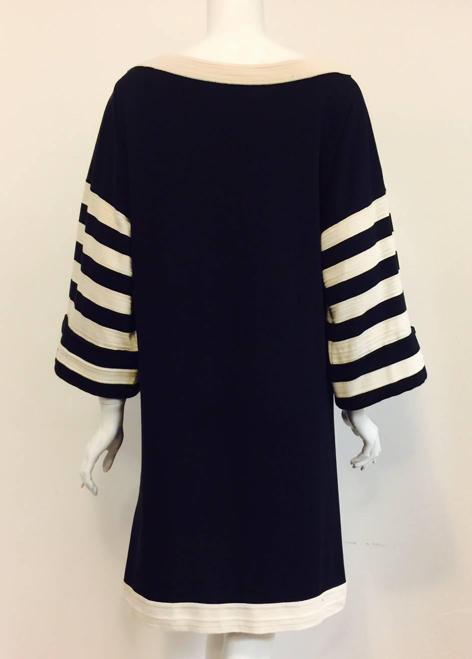 Traveling to Venice?  Chanel Navy and Ivory Striped Cotton Bateau Day Dress is as comfortable as it is chic!  Features sophisticated shift silhouette, banded ivory trim, and cuffed bracelet bell sleeves.  Whimsical nautical look even incorporates