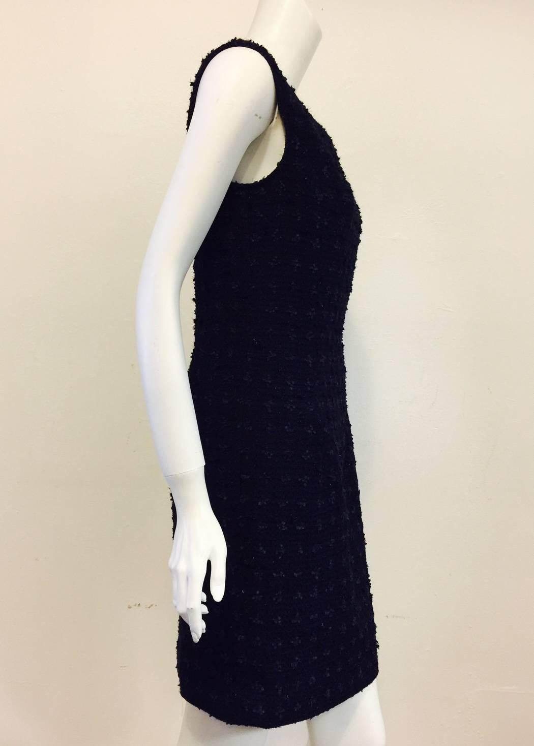 This Oscar de la Renta dress perfectly marries old-world techniques with modern design.  Features a sophisticated black and navy woven tweed fabric shell, sleeveless design and classic, knee-length.  Round neckline and rear hidden zipper with hook