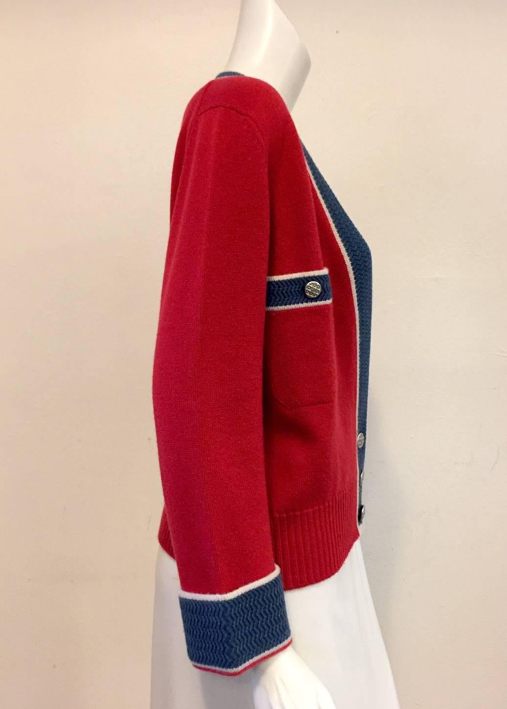Chanel Red and Slate Blue Cardigan is deserving of a "Varsity Letter"!  Features exquisite cashmere, wide chevron-patterned banded trim, and 3 silver tone signature button closure.  Two buttoned pockets.  Made in The United Kingdom.  Above