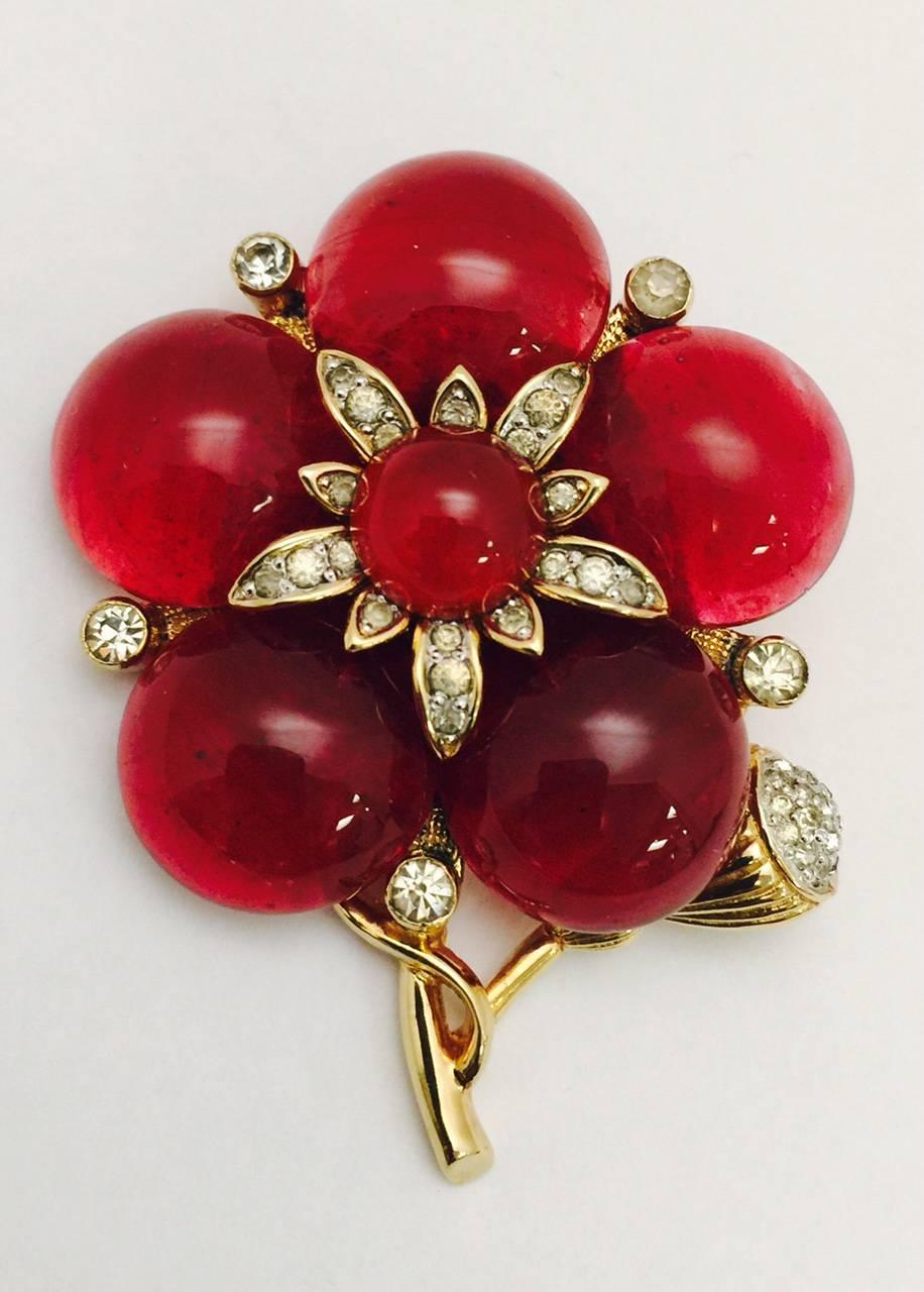 Nettie Rosenstein pieces are highly collectible and oh, so wearable!  This fabulous vintage flower brooch features plump petals in red gripoix.  Another red gripoix stone graces the center, accented by a burst of crystals set in gold tone. Five