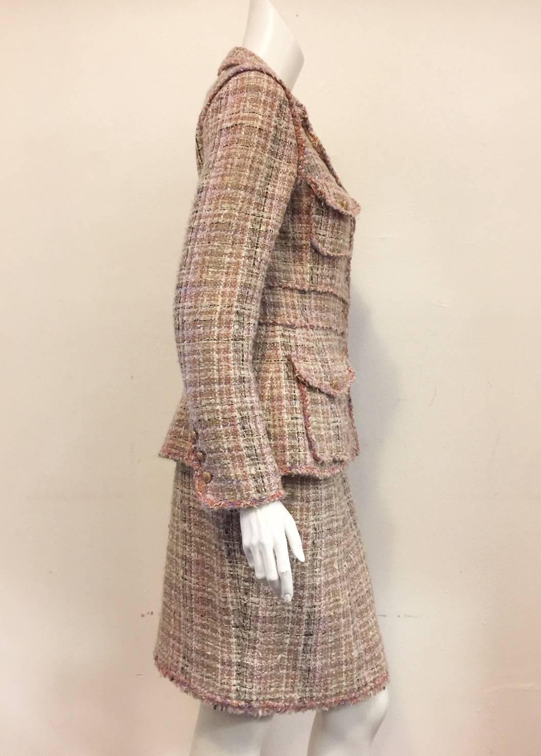 Chanel Blush Pink Skirt Suit is fit for "Mademoiselle" herself!  Features signature mohair, cotton and wool boucle tweed, gold tone buttons, four buttoned flap patch pockets on jacket, and classic  straight skirt. Banded waist on jacket