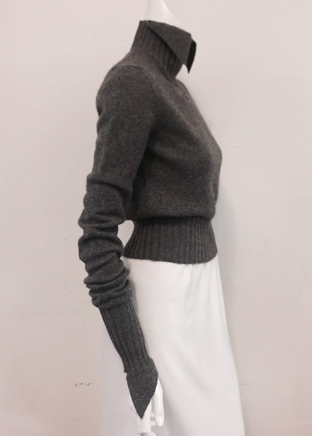 Chic to a fault, this Chanel Heather Grey Mock Turtleneck is a must for any lover of Lagerfeld's designs!  Features luxurious cashmere and wide banding at neck, waist and cuffs.  The "Wow Factor"?  Mock turtleneck features winged collar