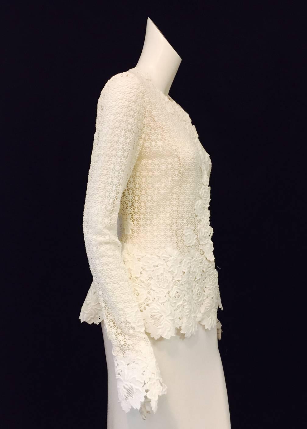 Oscar de la Renta Ivory Crochet Jacket is unabashedly feminine, dramatic and chic!  Collarless design features fitted silhouette, elongated sleeves, and 6 hidden snap closure.  Finished with dramatic floral applique at neckline, hem and sleeve