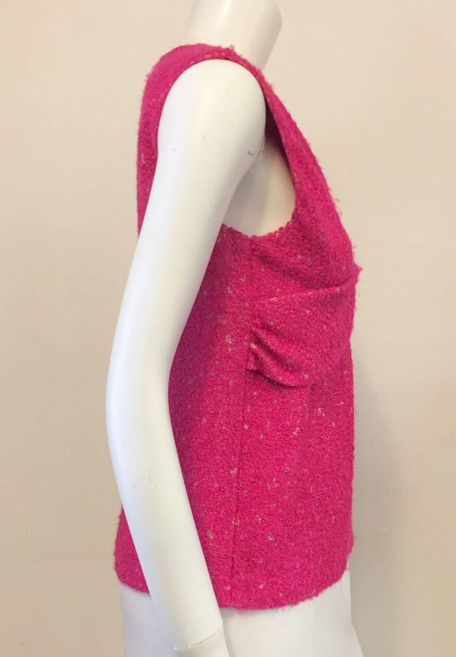 Chanel Hot Pink Sleeveless Top is ageless and timeless!  Features signature boucle fabric and draped front with feminine knot.  Rear hidden zipper with hook and eye closure.  Fully lined in hot pink silk.  A gold tone signature pin with ruby red