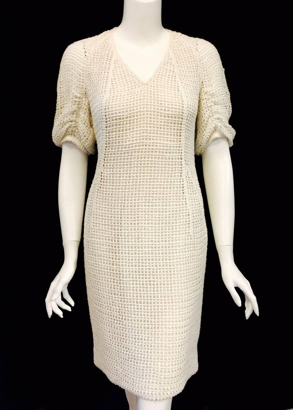 Investment dressing at its best! Based in Switzerland, Akris has become a favored brand of executive women worldwide.  Ivory Cotton Crochet V-Neck Sheath With Ruched Sleeves will quickly become a favored dress.  Alluring neutral color complements