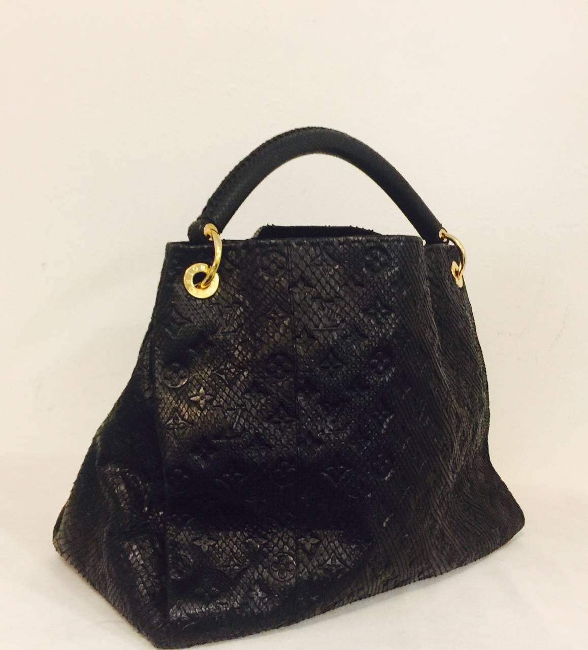 Limited to only 50 of these in circulation in the US, this Louis Vuitton Black Python Empriente Artsy MM Bag is worthy of any collection celebrating fine handbags in general and 'Louis