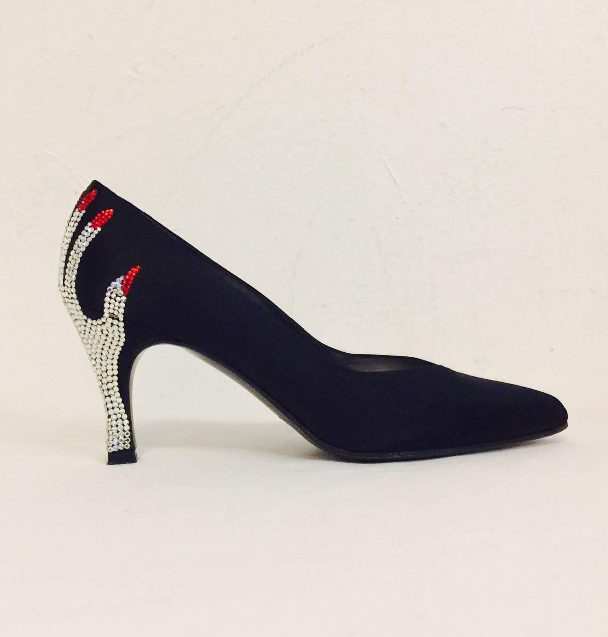 Make an entrance and an unforgettable exit when wearing these whimsical black satin pumps from Stuart Weitzman.  Each 