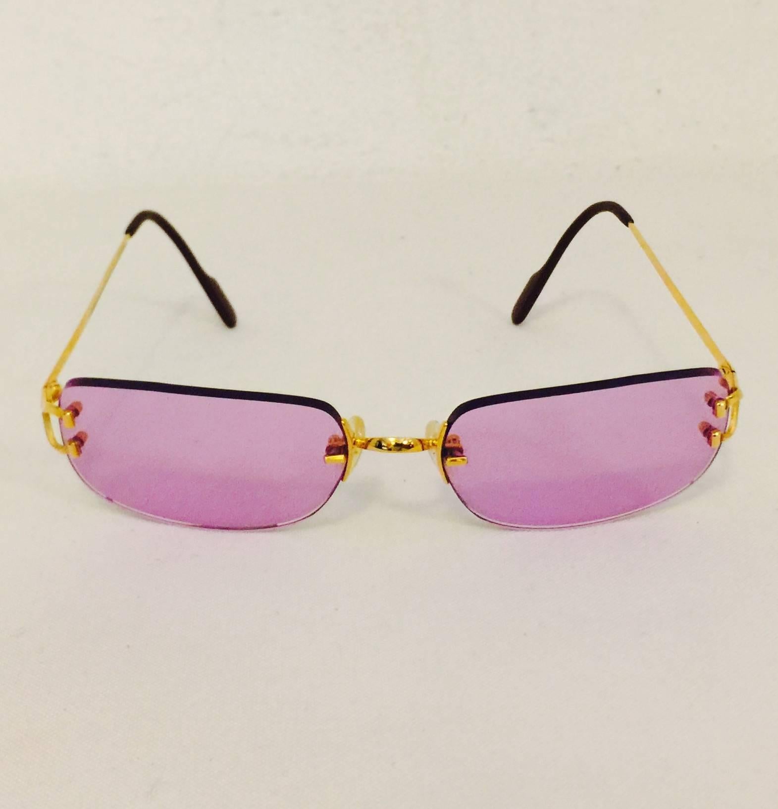 Cartier Rimless Sunglasses are a must for all connoisseurs of this legendary purveyor of fine gems!  Features sophisticated rounded, somewhat rectangular, lenses tinted a most feminine shade of rose pink.  Gold tone hardware finish the look!  Made