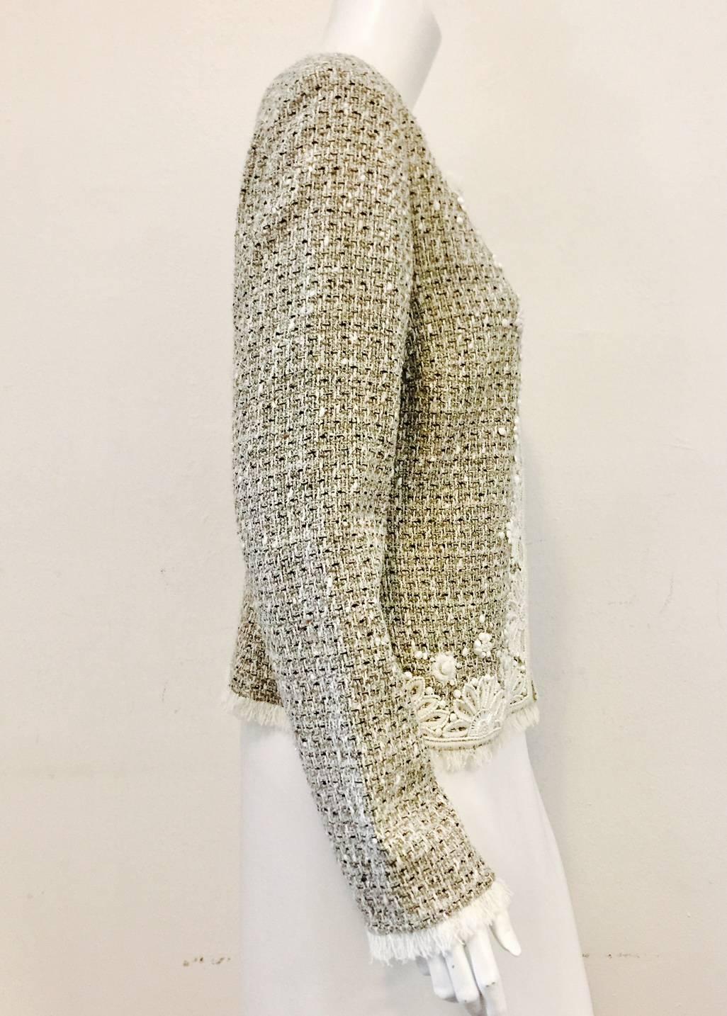 St. John designs are highly favored by women who desire wearable, classic silhouettes that pack with little fuss.  This multicolor tweed jacket is no exception!  Features neutral beige, taupe  and black colors with just a the right amount of gold