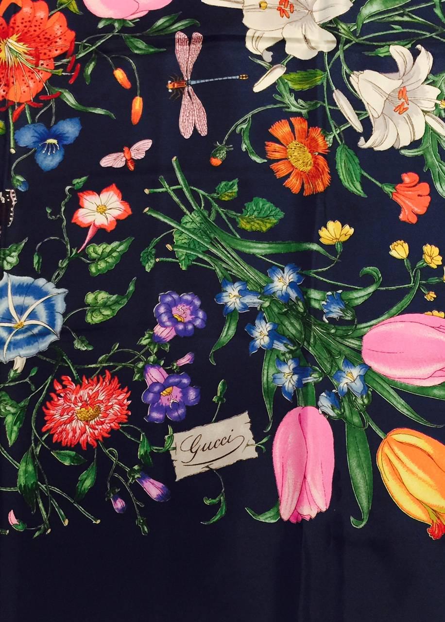 Gucci Navy Silk Twill Scarf is perfect for dressing up a plain suit or dress!  Features a Garden Multi-Floral Motif that is in full bloom!  Dragonflies and butterflies are the finishing touches.  Excellent Condition!  Made in Italy.  