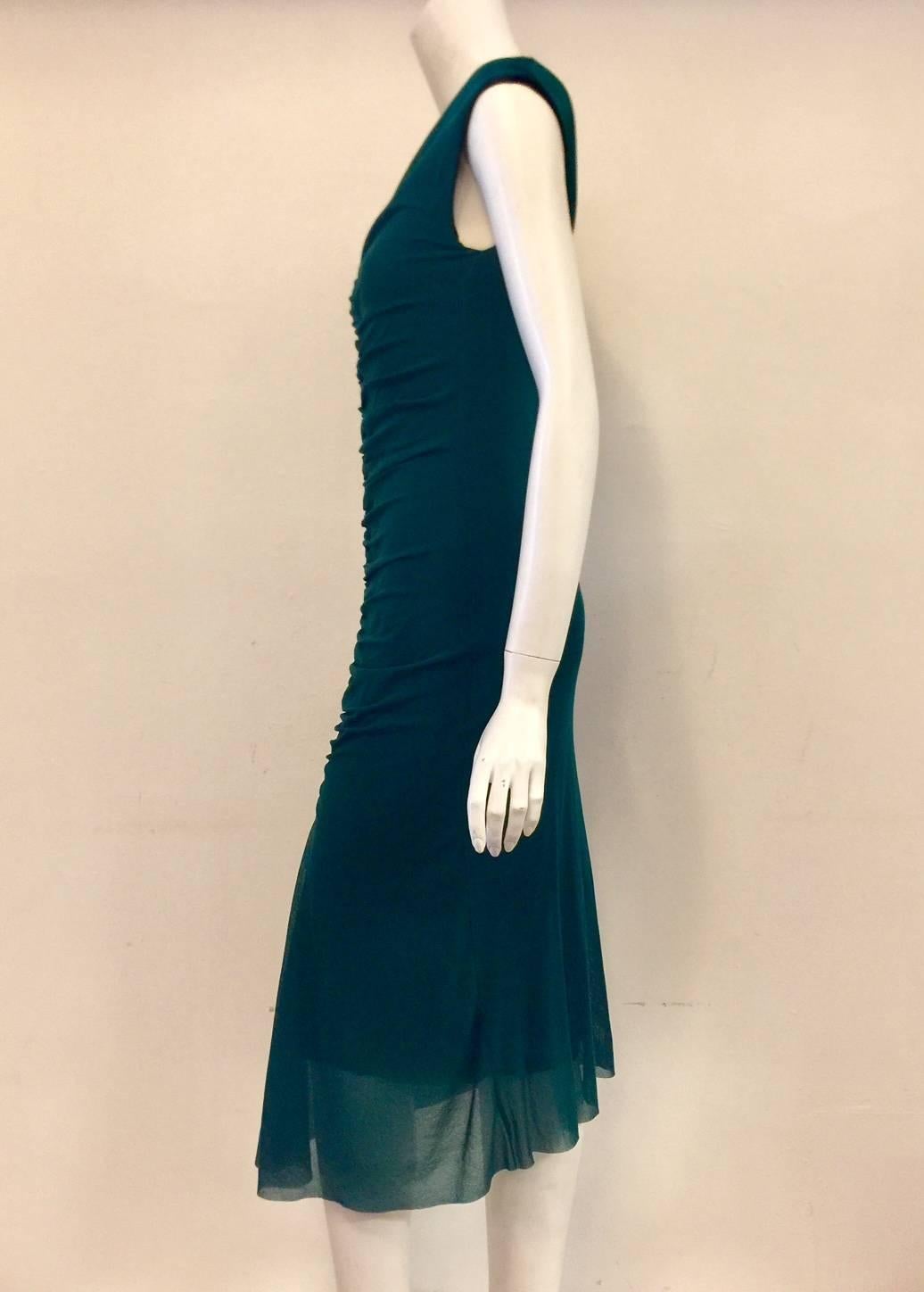 Fuzzi Forest Green Sleeveless Cocktail Dress features V-Neckline and sophisticated longer length.  Ruched front and slightly shorter, tiered lining are the finishing touches!  Will quickly become a favored traveling companion.  Made in Italy. 