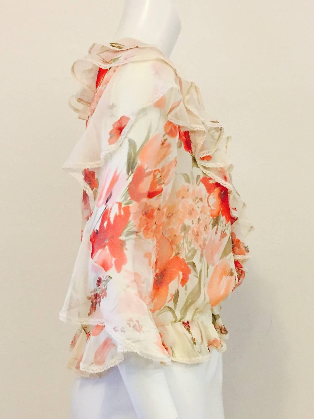  Valentino silk floral blouse is feminine to a fault!  Features classic blouson silhouette and layers of diaphanous ivory silk chiffon printed with a various red and peach tulips and other exotic flowers.  Elbow length sleeves, front and hem are