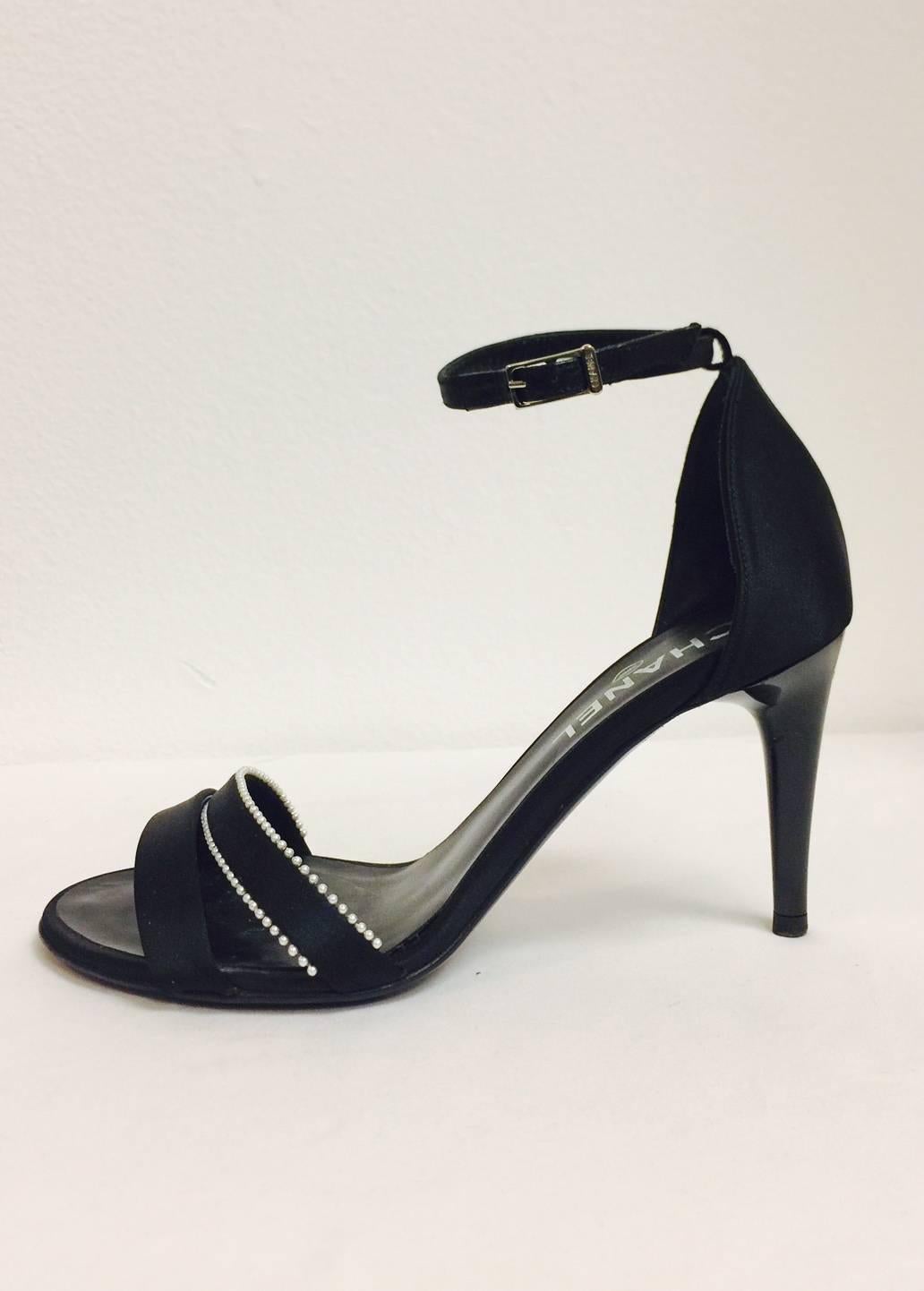 Chanel Strappy High Heel Sandals are perfect for "Dinner and Dancing"!  Features ultra-luxurious black satin bands across the vamps and adjustable ankle straps with logo buckles.  Black satin counters and leather soles/insoles. Black shiny