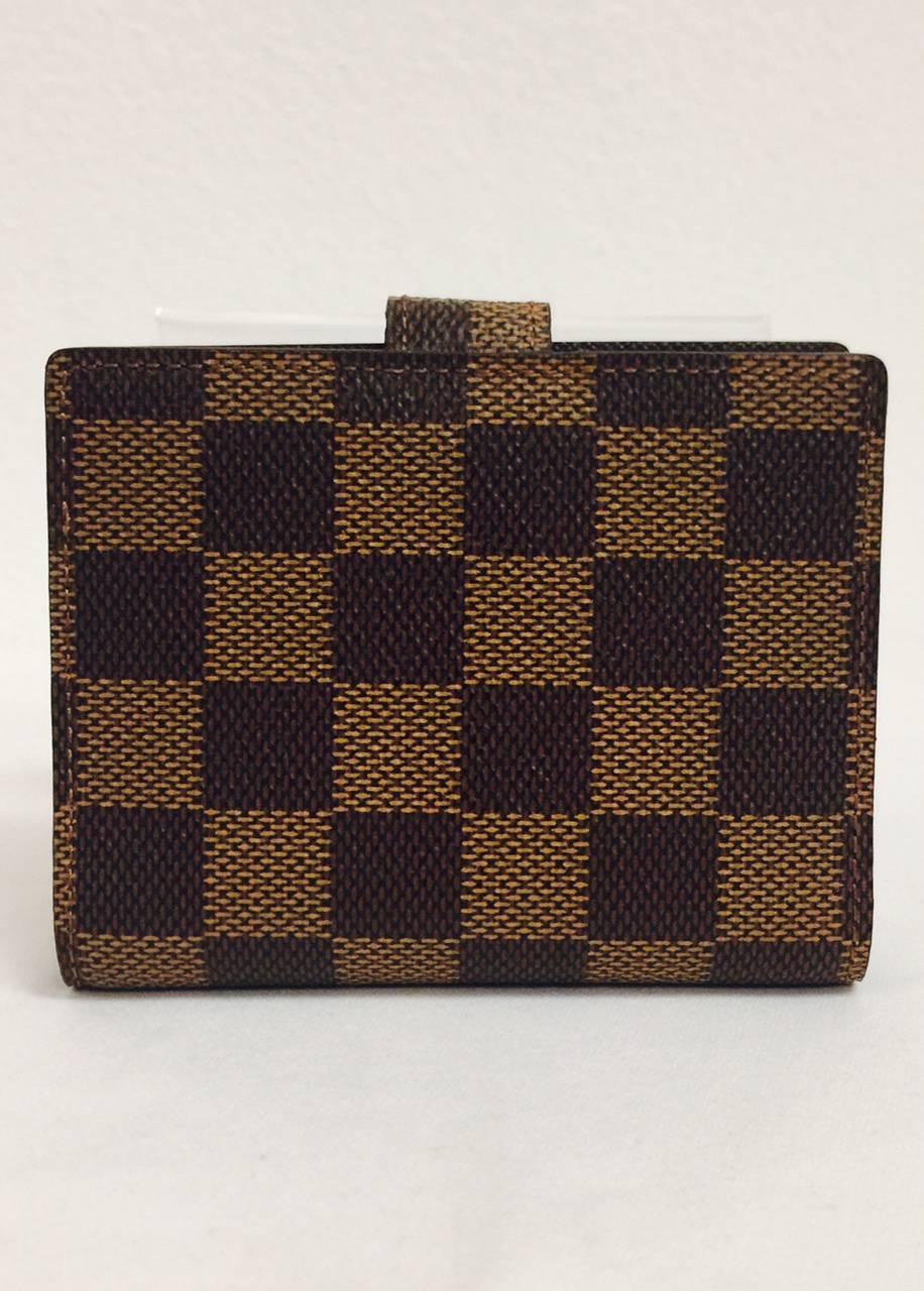 Louis Vuitton's Damier Canvas is a wonderful alternative to the iconic monogram print that is synonymous with all things "Louis".  Features Ebene Damier canvas allover, chocolate leather lining and three card slots.  Clear plastic insert
