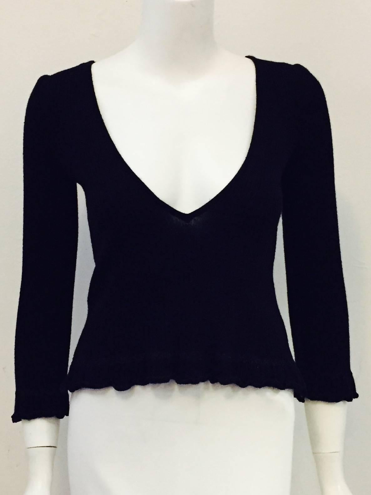 Casual, yet chic, Chanel Black Cashmere Pullover will quickly become a favored travel companion!  Features exquisite cashmere with just the right amount of "stretch", round neckline, deep V back and ruffled, lettuce edged hem and cuffs. 