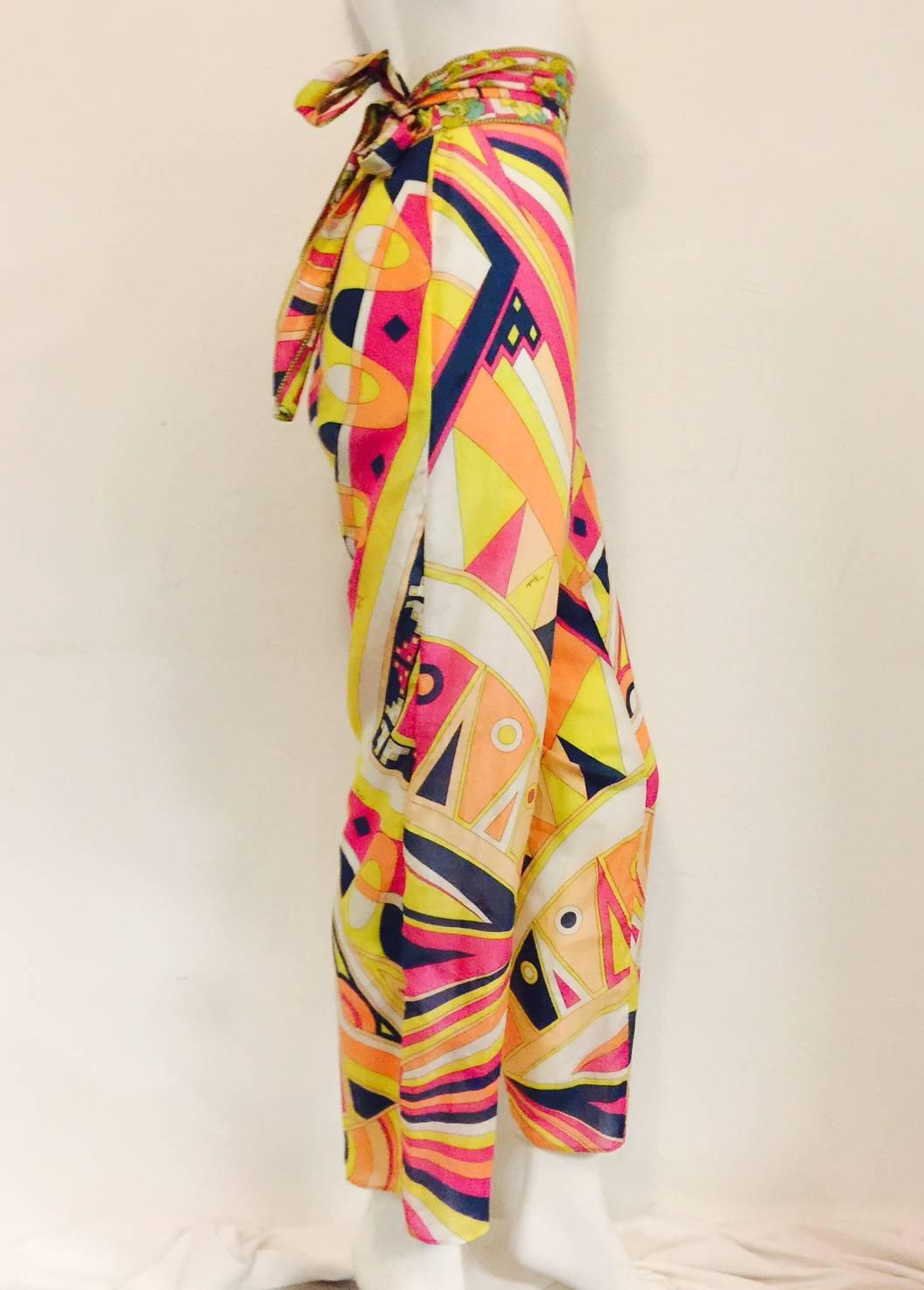 These cotton blend pants celebrate Pucci's Signature Geometric Multi Color Print. Features wide leg silhouette and side zipper.  Dramatic bandeau waist with long sash finish the look!  Perfect casual chic statement around the pool, at sea, or while