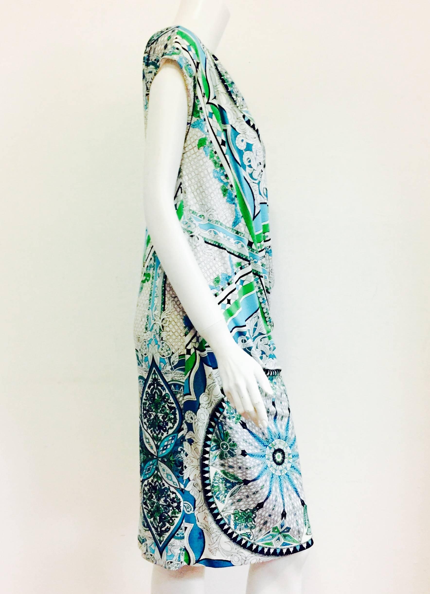 In the abstracted colorful style we've come to know and love, this Emilio Pucci dress is a timeless addition to any wardrobe. Featuring soft and silky viscose fabric in a geometric print in shades of blues and greens. A sleeveless style that hits