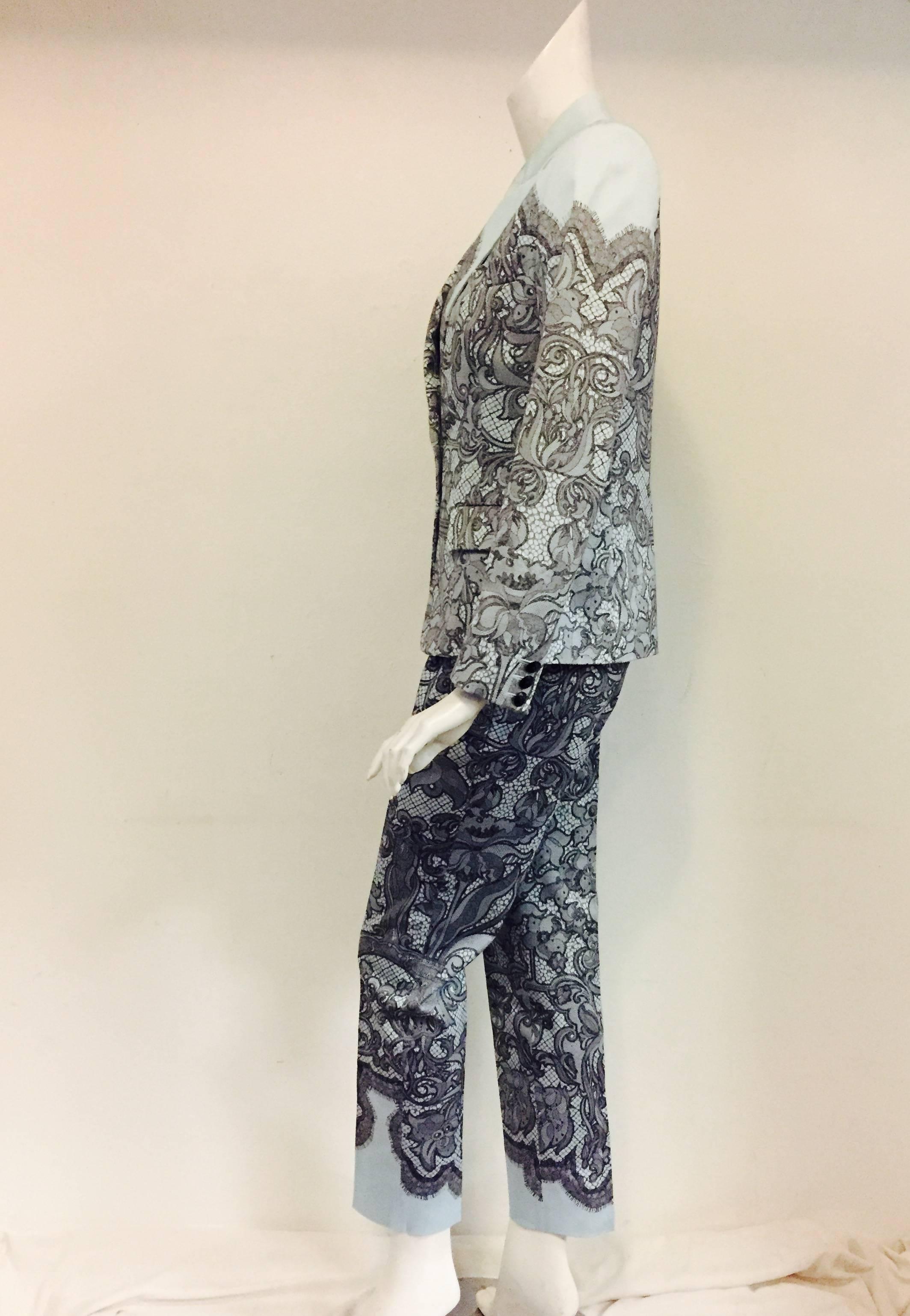 Pant Suit In Light Blue Background With Black Lace is a must for any devotee of Emilio Pucci's designs!   Jacket has single button closure and 2 front flap pockets with one addition small faux pocket.  Notch collar.  Sleeves are finished with 3