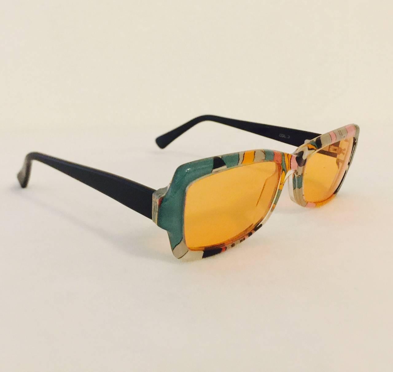 Palm Beach, Positano or Pucci? This vintage pair of iconic green, pink and orange signature print sunglasses by Emilio Pucci are a must for any 