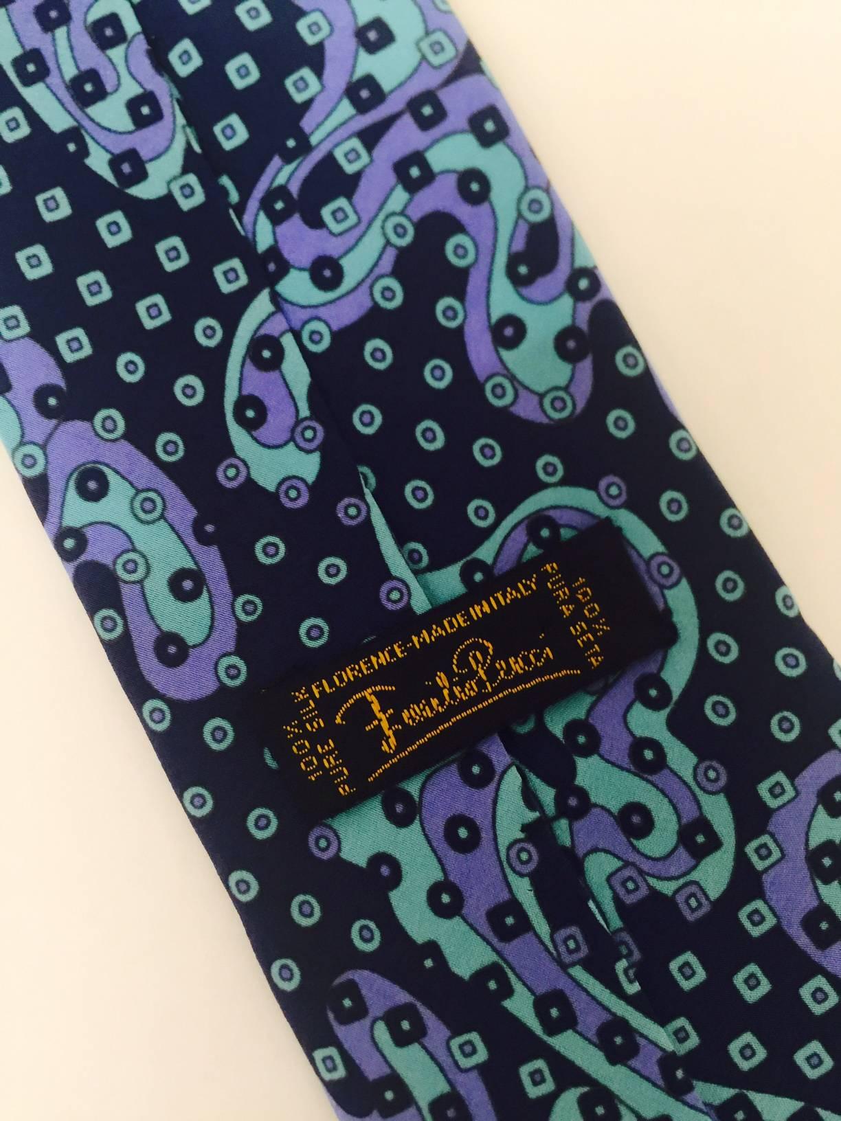 Always known for outstanding prints, this tie has all the elements of the fab psychedelic era in tones of blue on blue. Great addition for the Pucci collector.   54 inches long, 3.125 inches wide. 1970's