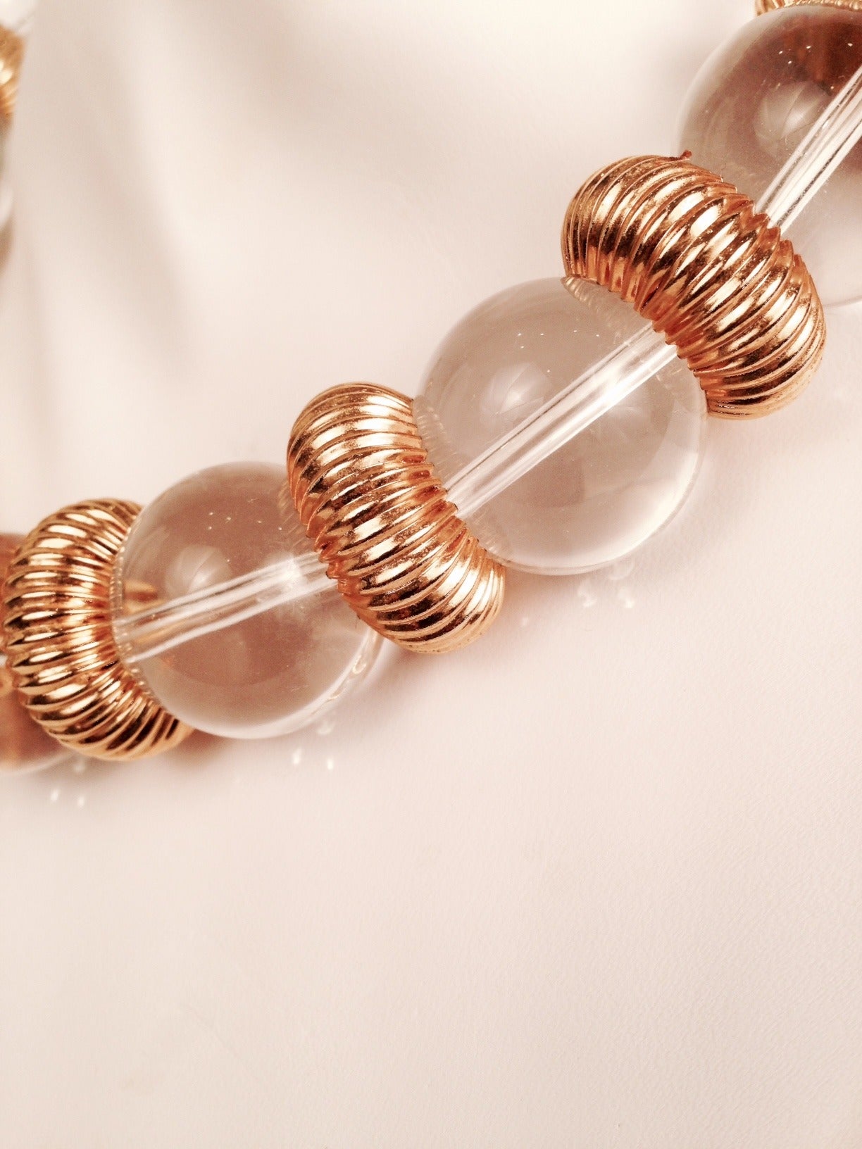 Kenneth Lane Lucite Choker features impressive, clear lucite beads separated by ribbon, gold-tone rondelles.  Easy and breezy!  Perfect for travel.  Simply beautiful, timeless...ageless!