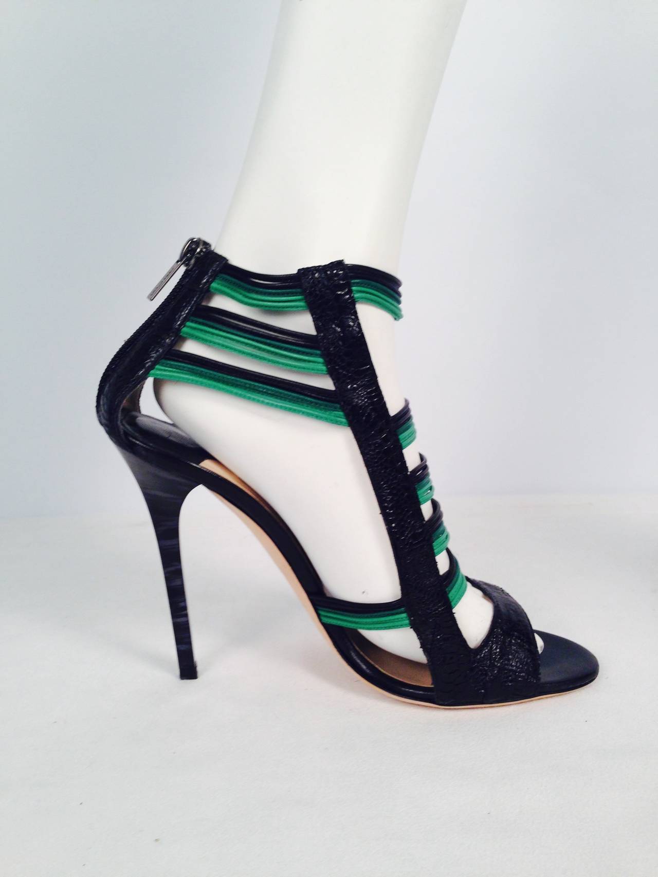 All eyes will be on your feet when wearing these high heel caged sandals from Jimmy Choo!  Crafted from python leather, these open-toe sandals feature basic black and glorious green straps across the feet.  Rear zip fastenings on the heel counters