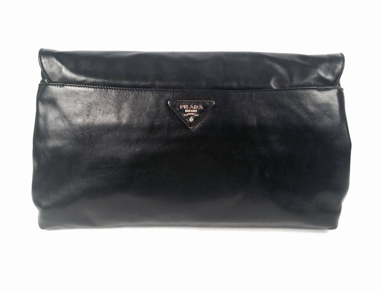 Prada Nappa Leather Smoking Lips Clutch has become a highly desired collectible since Miuccia Prada introduced it in 2012.  Features include soft, supple leather and polished gold tone hardware.  The piece de resistance?  A showstopping cigarette