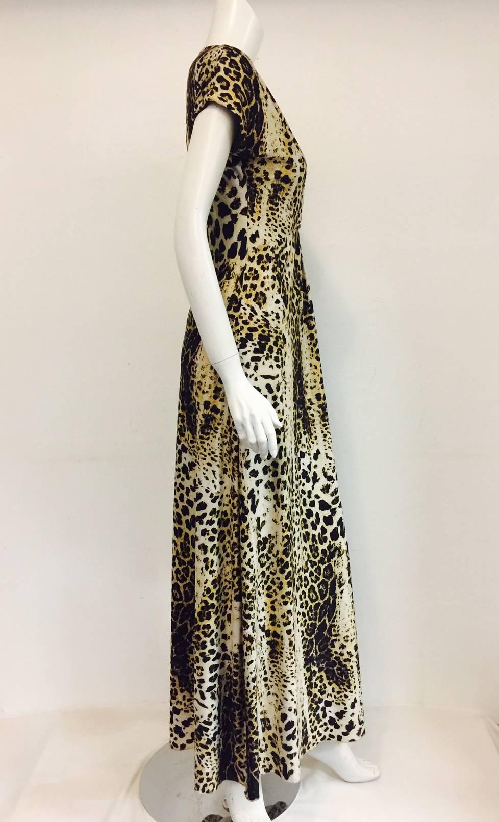 Roberto Cavalli Internationally renowned House of glamour and flamboyancy in all their designs, and this dress is no exception!  V neck, dropped sleeves, quasi empire waist with 2 bronze tone ornaments at gathering, informal yet dramatic a la