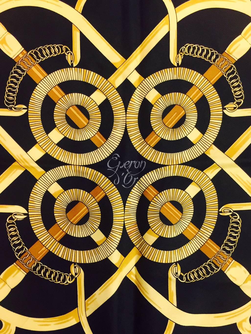 Hermes scarves are full of history and heritage including this outstanding illustration of the Eperon d'Or (Golden Spurs) created by Henri d'Origny.  With a dramatic black border and soft yellow background with distinguished brown accents.  100%