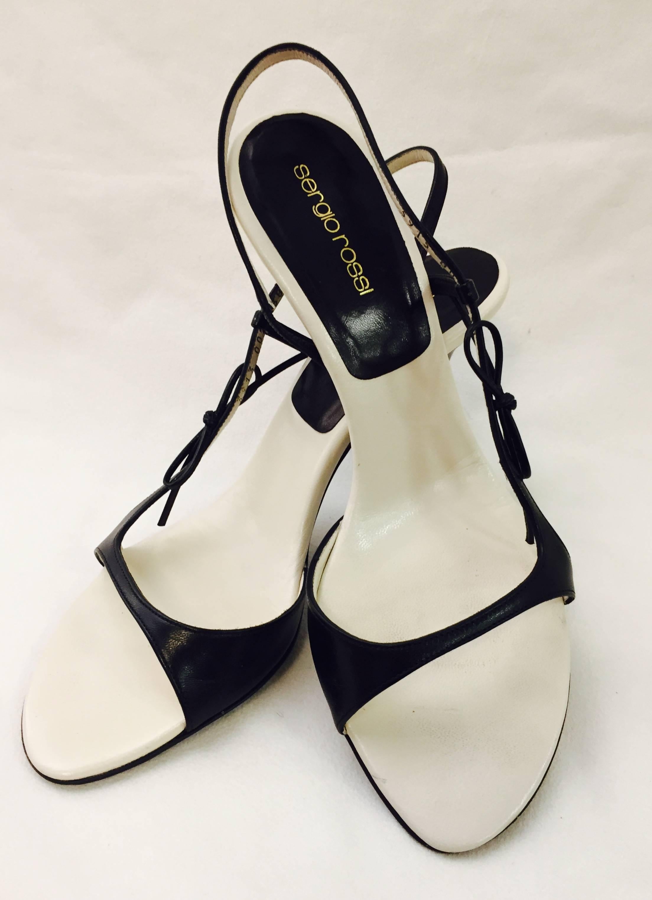 Sergio Rossi's Italian heritage is celebrated with these sophisticated, slightly suggestive, strappy heels! The side strap is highlighted with a cord leather bow to one side.  Ivory leather sole. Heel Height: 4