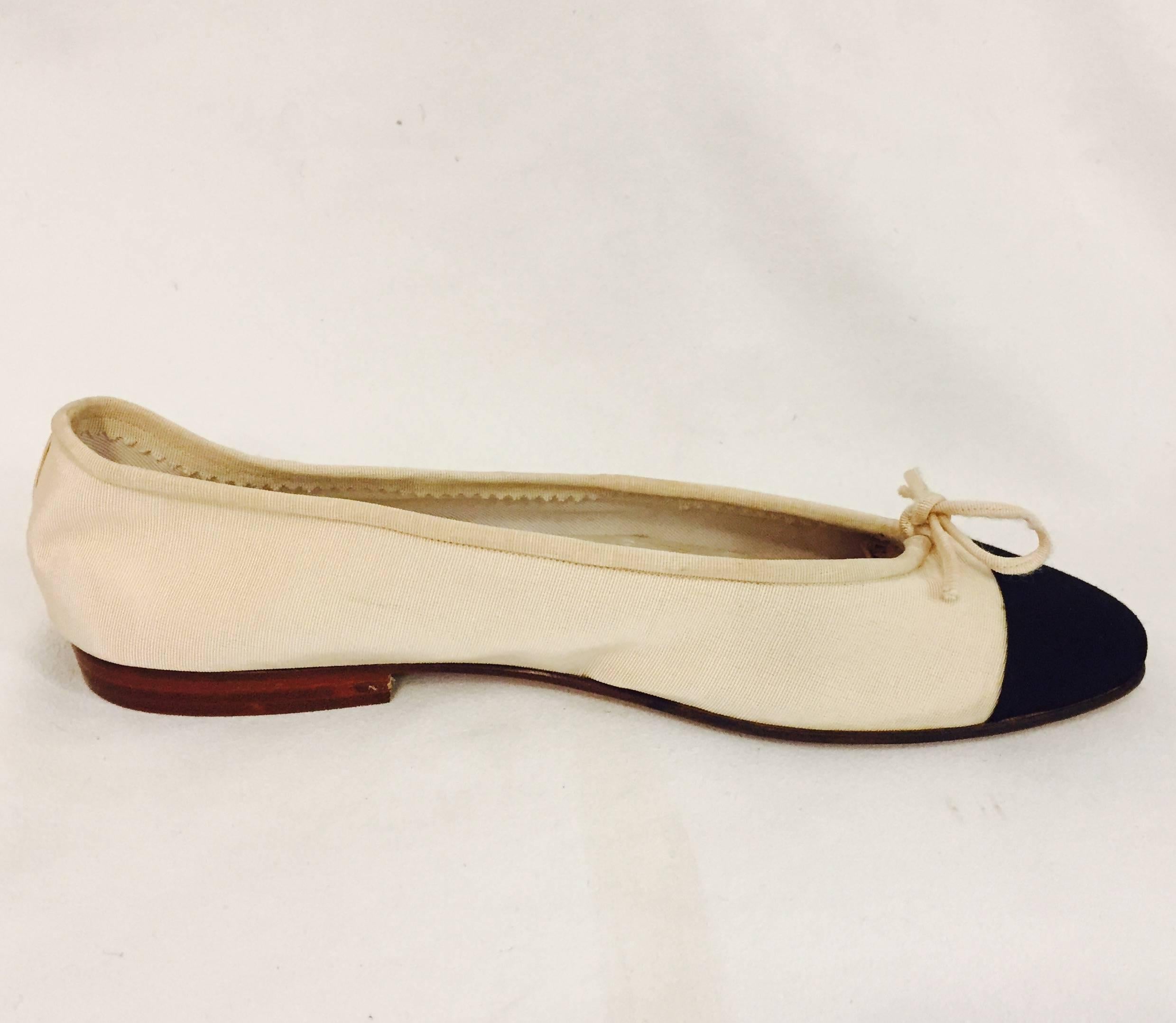 Chanel shoes are highly coveted!  Especially these beautifully crafted grosgrain ballet flats in beige and black with iconic cap toes!   A  grosgrain cord ties into a bow and finishes the look!  Leather soles, insoles, and lining.  In excellent,
